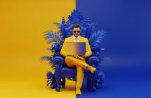 modern-man-working A modern man in a vibrant yellow suit, wearing sunglasses, working on a sleek silver laptop. He is seated on an ornate royal blue throne-like chair with stylized plant elements. The background is split between solid vibrant yellow and deep royal blue. Digital art, 3D render, high detail, clean lines, minimalist, futuristic, bold colors.